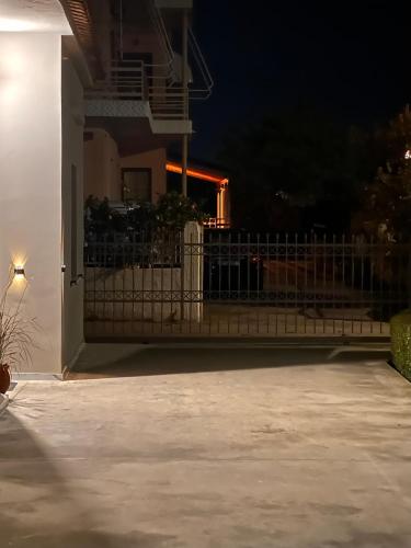 a fence in front of a house at night at Aura House in Koutsopódhion