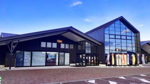 a large black building with glass windows at Toyoko Inn Hokkaido Shin Hakodate Hokuto eki Minami guchi in Hokuto