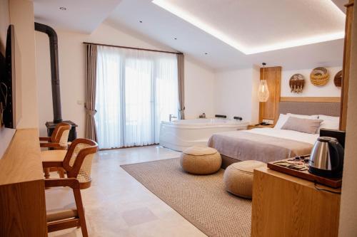 a bedroom with a bed and a bath tub at VillaQua Boutique Hotel in Şile