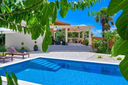 a swimming pool in a yard with a house at Crassula Summer Villa with Private Pool in Kras