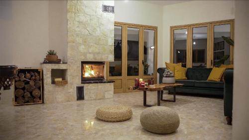a living room with a fireplace and a couch at Mountain Retreat in Troodos