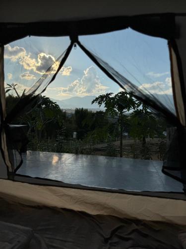 a view from the inside of a tent looking through a window at Pai Chao Kha in Pai