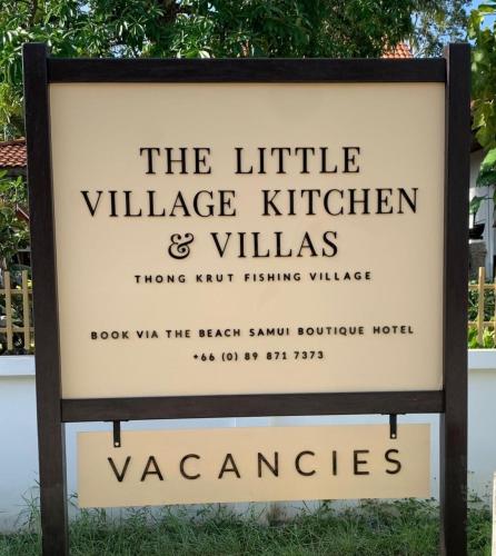 a sign for the little village kitchen and villas at The Beach Samui in Taling Ngam Beach