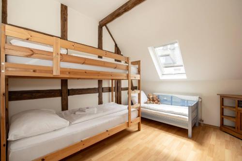 a bedroom with two bunk beds and a crib at Villa Ennert in Winterberg