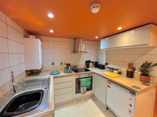 a kitchen with a sink and a dishwasher at Brecon serviced apartments- Kian Perrott Properties in Brecon