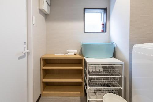 a laundry room with a tub and a sink at H2H Dotonbori in Osaka