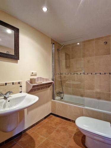 a bathroom with a sink and a shower and a toilet at Casa Del Ingles - Luxury Private Villa & Pool in Rural Valley in Pontevedra