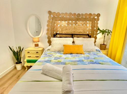 a bedroom with a bed with a wooden headboard and a mirror at In Love Zamora 3 habitaciones in Zamora