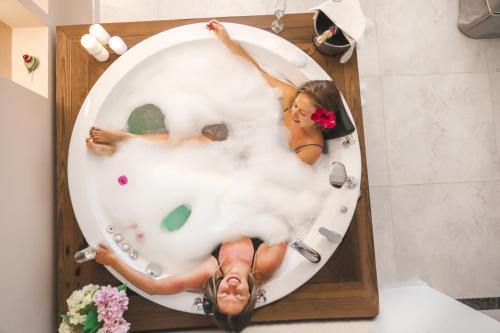 a picture of a woman in a bath tub at Rammos Managed By Dedeman in Bodrum City
