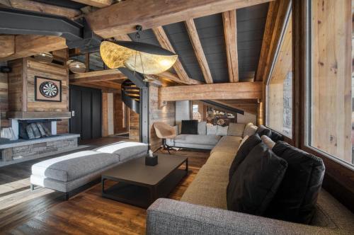 a living room with a couch and a table at Chalet Eden Roc in Tignes
