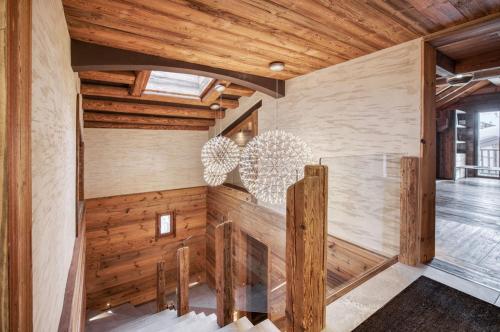 a room with wooden walls and wooden ceilings at Chalet Eden Roc in Tignes