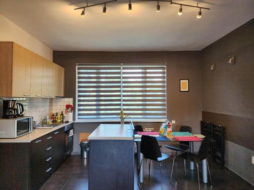 a kitchen with a table and some chairs and a counter at Sunny Central Apartment in Sofia