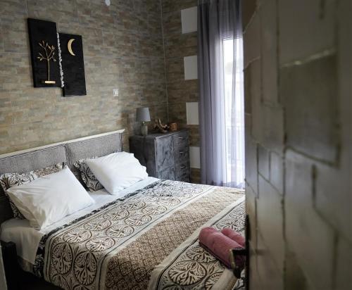 a bedroom with a bed with white pillows at ΩκεανιςHouse 1 in Preveza
