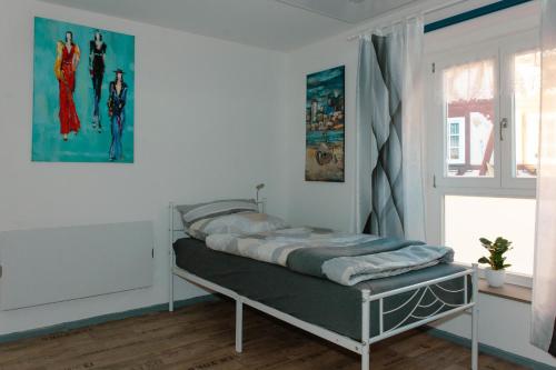 a bedroom with a bed in a room with a window at Winterzimmer in Homburg