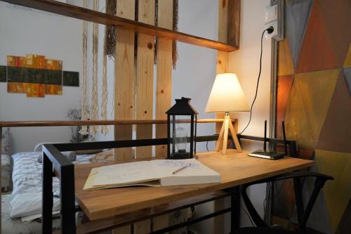 a desk with a lamp and a book on it at ΩκεανιςHouse 1 in Preveza