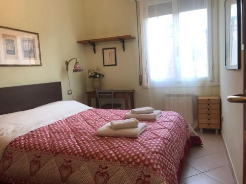 a bedroom with a bed with two towels on it at La casa di Gioia in Florence