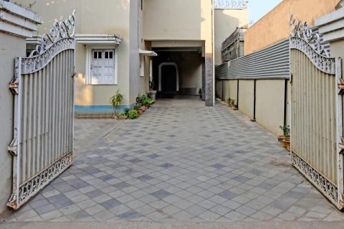 an empty hallway of a house with a fence at Archie Oasis in Bhubaneshwar