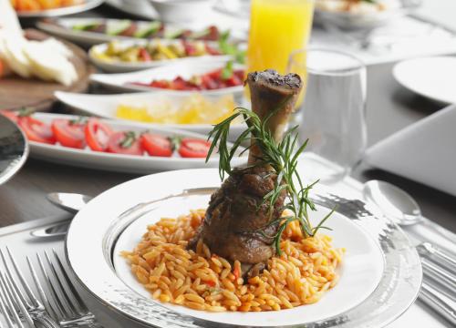 a plate of food with meat and rice on a table at Windsor Hotel & Convention Center Istanbul in Istanbul