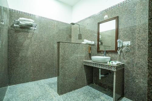 a bathroom with a sink and a mirror at Sandcastle Resort in Jaisalmer