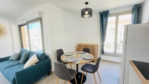 a living room with a blue couch and a table at Appartement Citadella 1 Calvi in Calvi