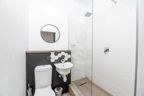 a bathroom with a toilet and a sink at N1 Hotel & Campsite Victoria Falls in Victoria Falls
