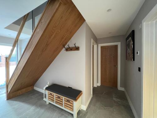 a room with a staircase with a bench in it at Brian’s Escape in Great Driffield