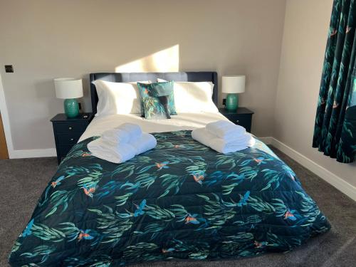 a bedroom with a bed with two towels on it at Brian’s Escape in Great Driffield