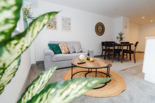 a living room with a couch and a table at George House Modern Apartments by VICHY in Hull