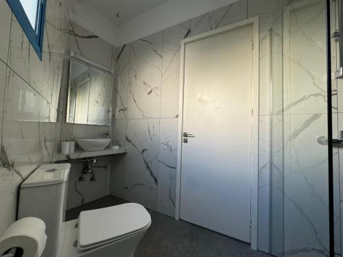 a bathroom with a toilet and a sink at Kefalonitis Hotel Apartments in Paphos City