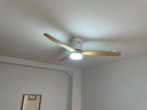 a ceiling fan with a light on a ceiling at KAIROS HOME y Garaje , Algemesí Home in Algemesí