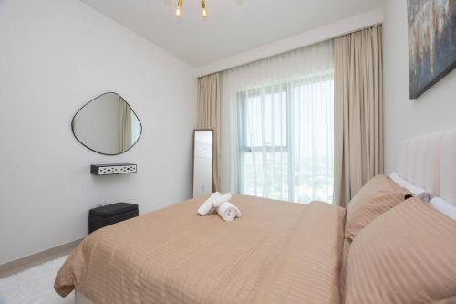 a bedroom with a bed with two towels on it at Sunny Downtown Retreat- Direct access to Dubai Mall in Dubai