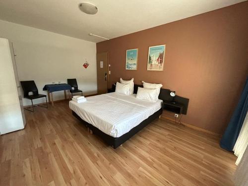a bedroom with a bed and a table in it at Primadom Aparthotel in Geneva