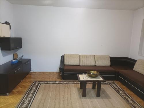 a living room with a couch and a coffee table at Стан in Prilep
