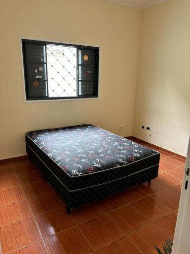 um quarto com uma cama num quarto com uma janela em Hostel do mineiro em São José dos Campos