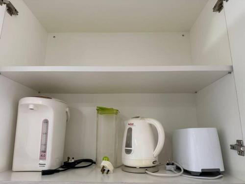 a kitchen with two appliances sitting on a counter at Riverbank Suite @ Waterfront KCH in Kuching