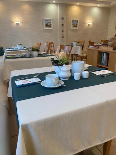 a table with bowls and cups on top of it at Pension Peterhof in Mörbisch am See