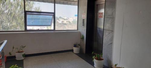 an office hallway with potted plants and a window at Hotel SSR GRAND in Hyderabad