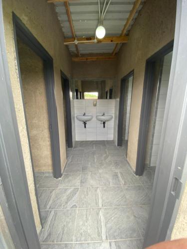 a hallway with two sinks in a bathroom at Mababe River Campsite in Mababe