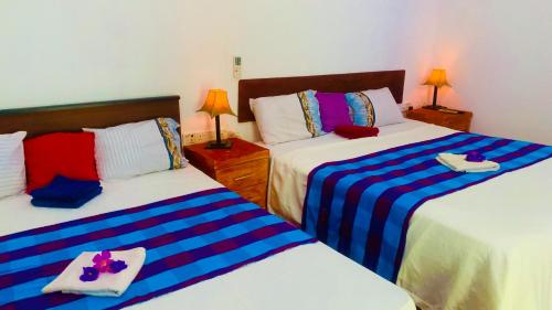 Postel nebo postele na pokoji v ubytování Aloe Home Stay