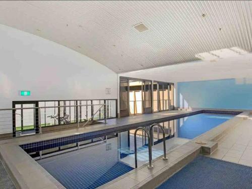 a large swimming pool in a large building at “Urban Oasis ” Central emporium apt ,Free Parking in Melbourne