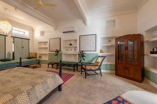 a bedroom with a bed and a table and chairs at Sum Jaipur in Jaipur