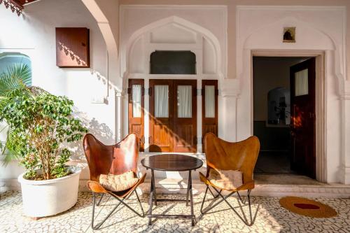 a group of chairs and a table in a room at Sum Jaipur in Jaipur