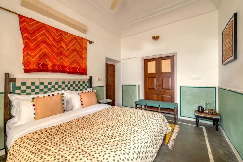 a bedroom with a large bed in a room at Sum Jaipur in Jaipur