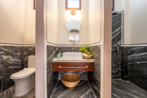 a bathroom with a sink and a toilet at Sum Jaipur in Jaipur