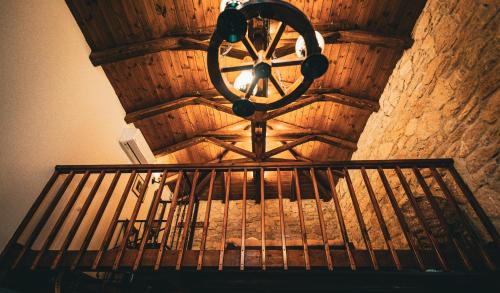 a wooden room with a clock on the top of a bed at Guesthouse Armakas in Kalavrita