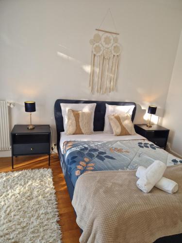 a bedroom with a bed and two night stands with lamps at Le Refuge D'anne De Bretagne in Blois