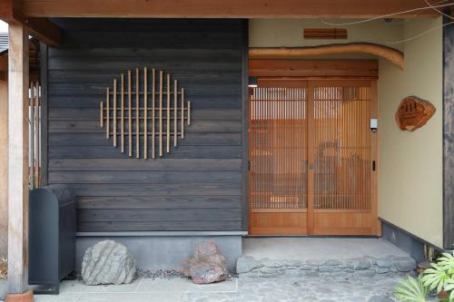 a front door of a house with a gate at 一棟貸しの宿 寂香庵 in Kamakura
