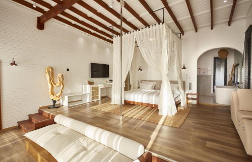 a bedroom with two beds and a tv in a room at Lov Faralya Beach & Nature Retreat in Faralya