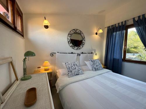 a bedroom with a bed and a mirror on the wall at Domus Tom Apartment with sea view Villasimius in Simius