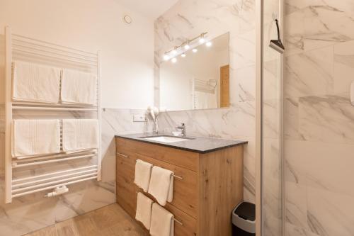 a bathroom with a sink and a shower at Alpenhof Chalets in Gerlos